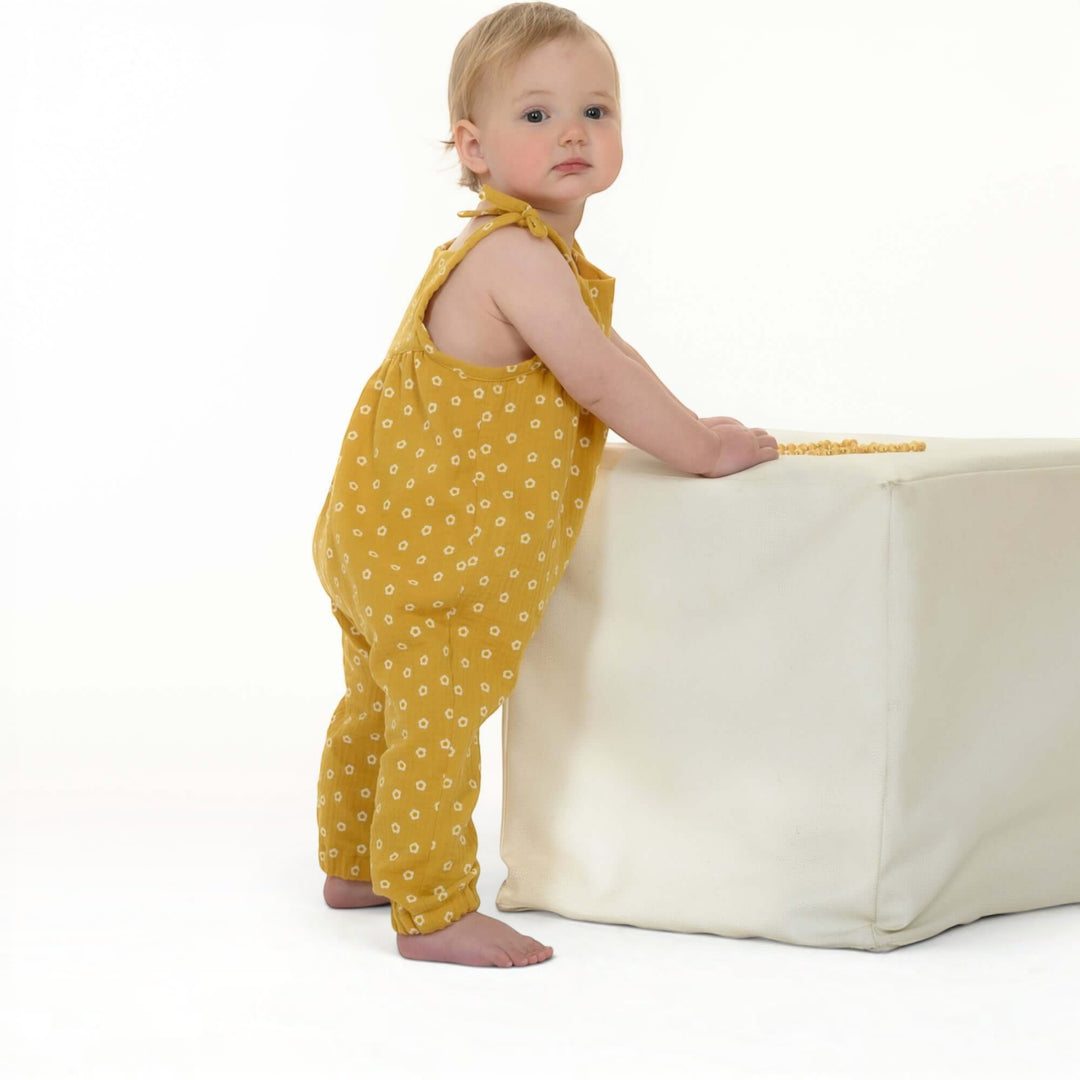 Schnittmuster Baby Mädchen Jumpsuit NELE PDF - Bequemer Overall für Kleinkinder in gelber Farbe mit Blumenmuster.