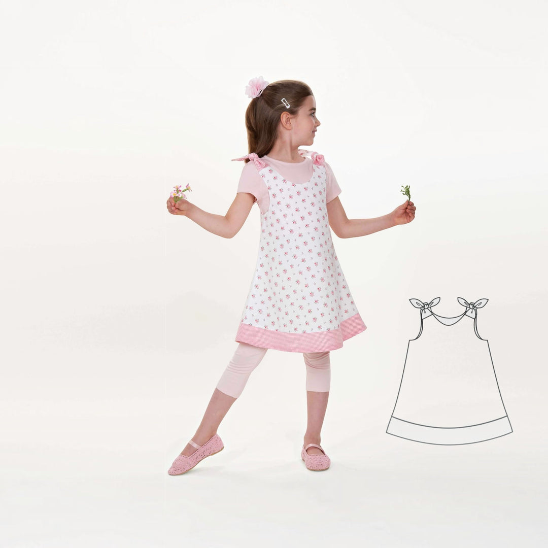 Tunika Kleid pdf Schnittmuster JULE ANTONIA STEFFI – 3-in-1 74/80–146/152, Mädchen in einem blumigen Kleid mit Schleifen und Blumen.