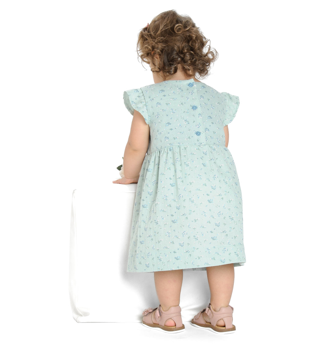 Schnittmuster Retro Kleid für Mädchen ELLA mit langen Ärmeln, Rückansicht eines Mädchens in einem blauen Kleid.