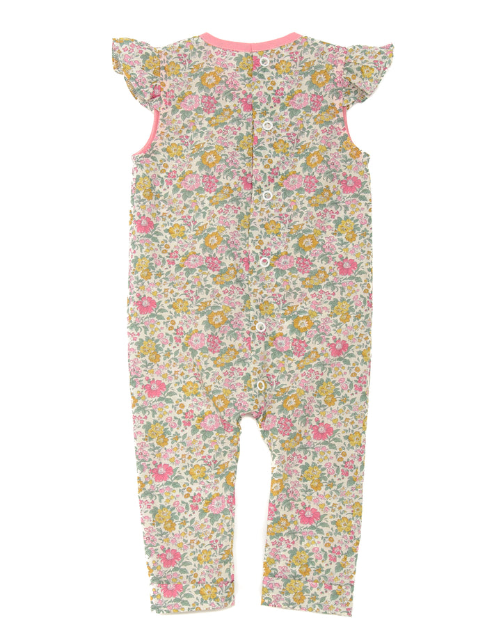 Schnittmuster Mädchenkleid MIA – Rückansicht des Baby-Jumpsuits mit floralem Muster und Volant-Ärmeln.