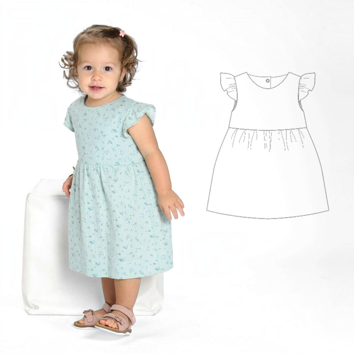 Schnittmuster Retro Kleid für Mädchen ELLA PDF – Mädchen in einem blauen Kleid mit Flora-Muster.