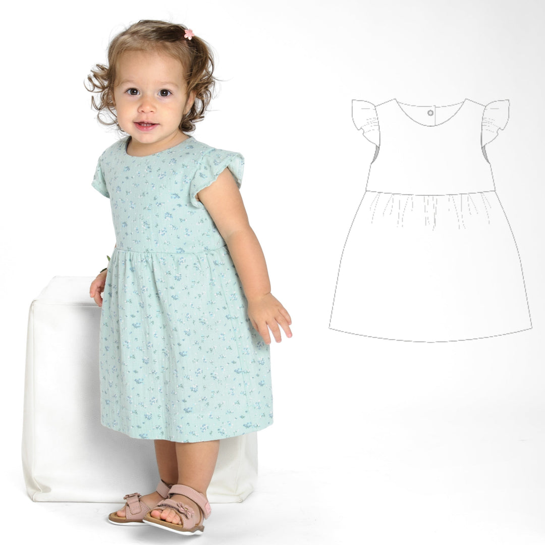 Schnittmuster Retro Kleid für Mädchen ELLA mit langen Ärmeln, abgebildet auf einem kleinen Mädchen in einem blauen Kleid.