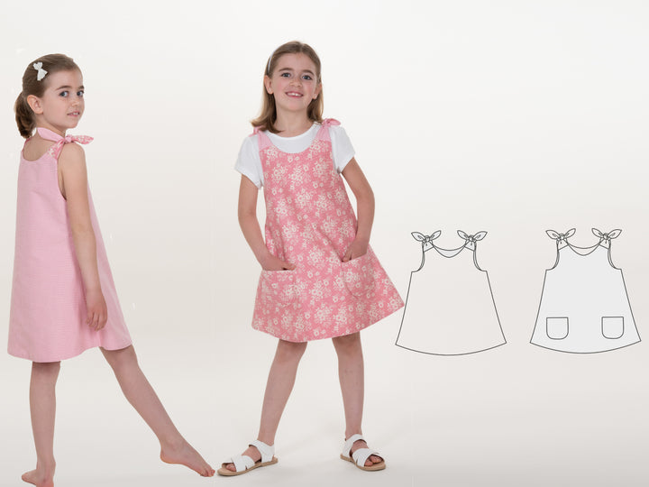 Schnittmuster Pinafore-Kleid für Mädchen JULE in rosa und gemustert, zeigt verschiedene Varianten und Designs.