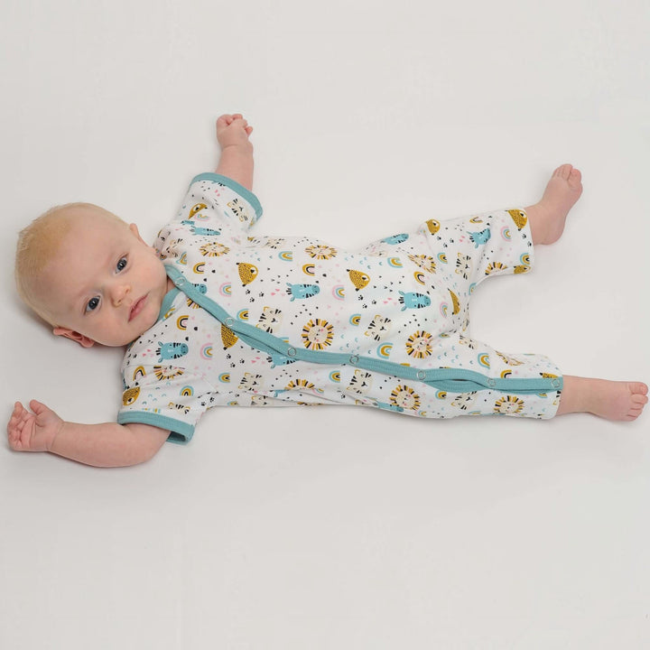 Baby Strampler PDF Schnittmuster LEON – 2-in-1 mit Druckknöpfen 50/56–98/104, ein Baby im Strampler mit buntem Muster.